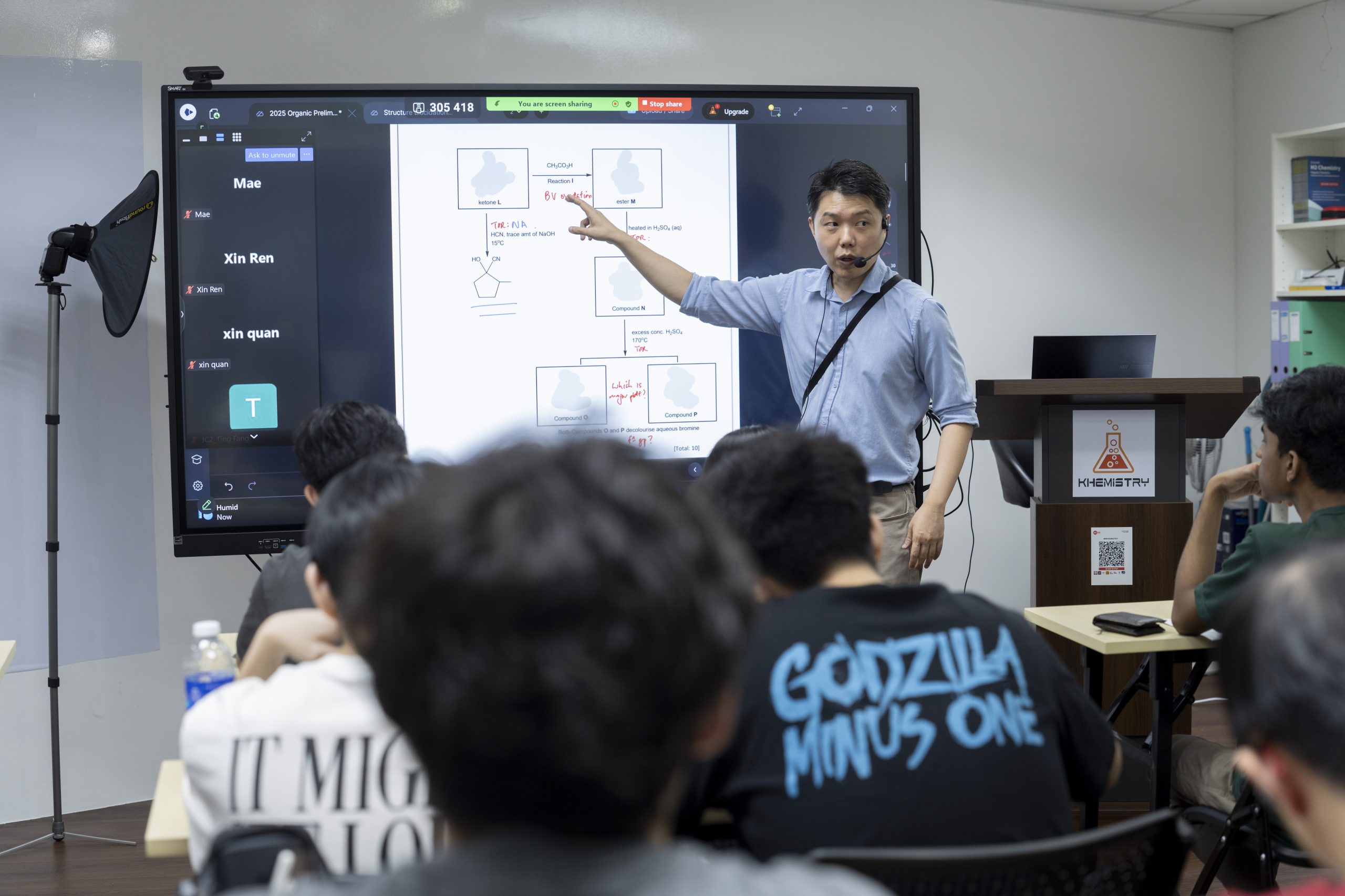 Mr Eric Kua taking a full H2 Chemistry class at the board